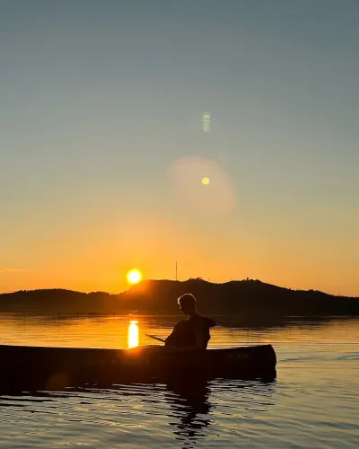Summer evening canoeing on the lake Rukajärvi, Ruka, Lapland