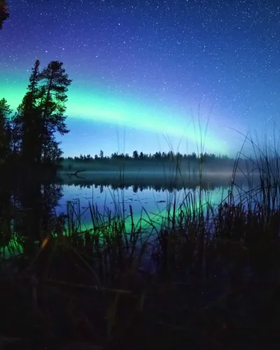 autumn northern lights in Ruka over the lake, Lapland.